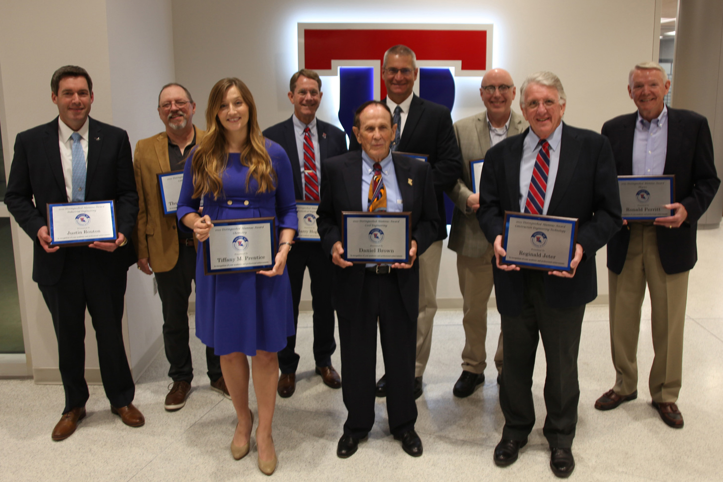 Distinguished Alumni with their plaques