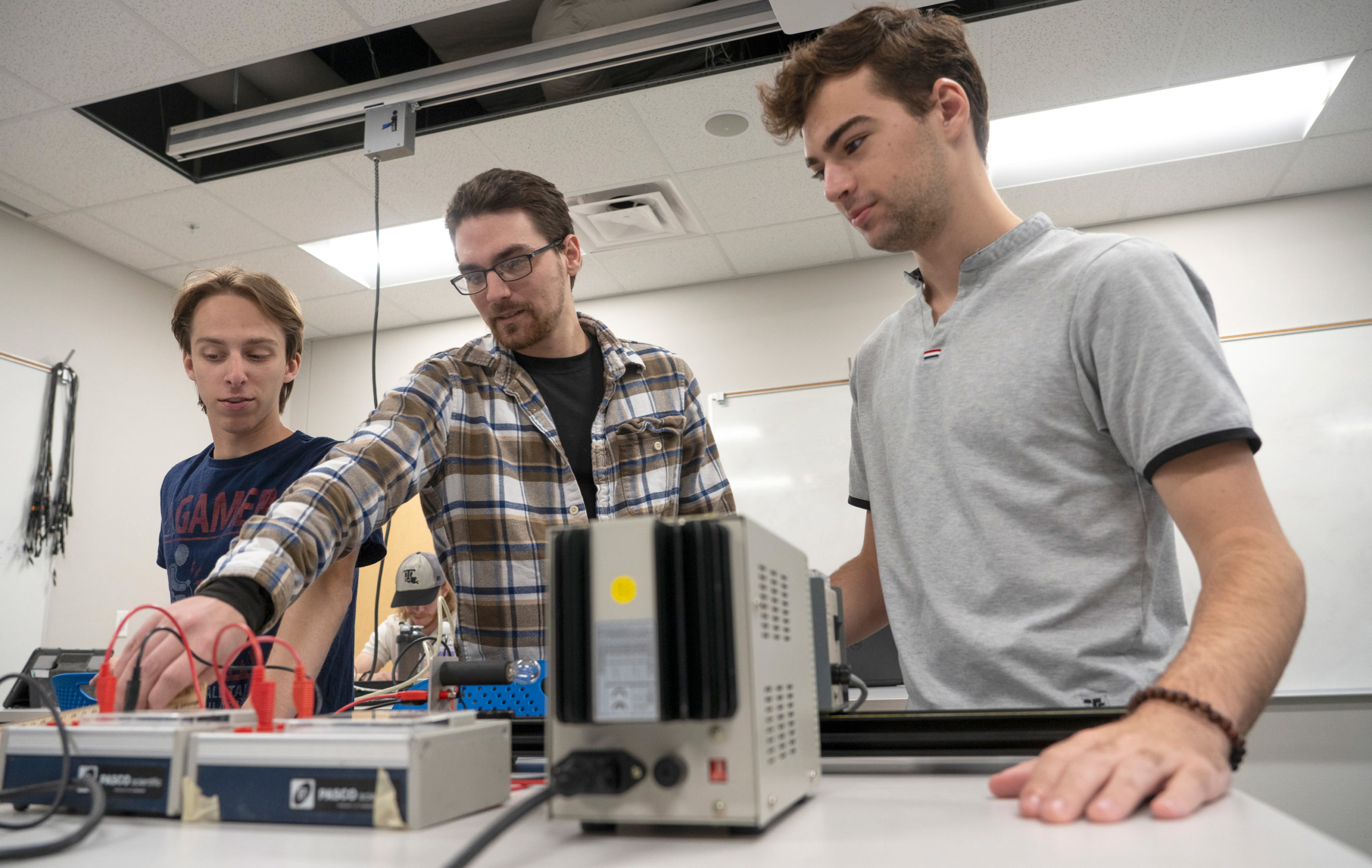 Physics students working with lab equipment