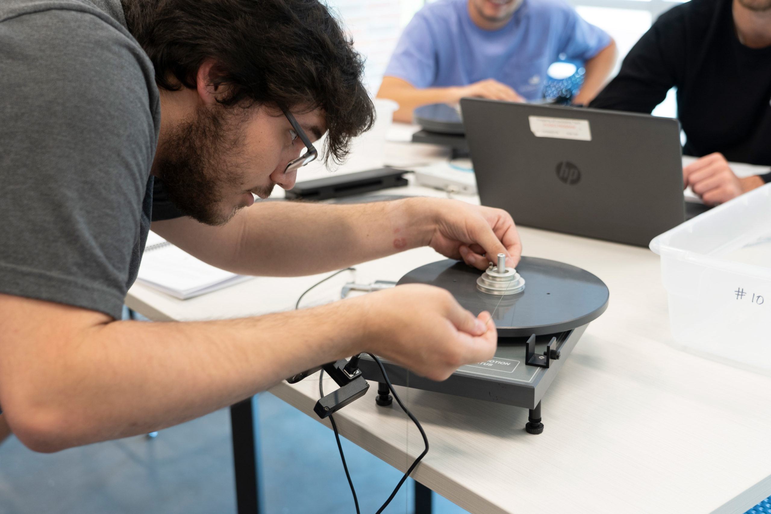 Physics student working with lab equipment